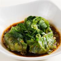 Green Dumpling · Vegan. Spicy. 4 steamed vegetable dumplings, topped with spinach and served with chili oil d...