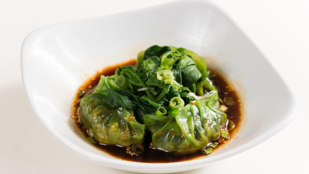 Green Dumpling · Vegan. Spicy. 4 steamed vegetable dumplings, topped with spinach and served with chili oil dressing.
