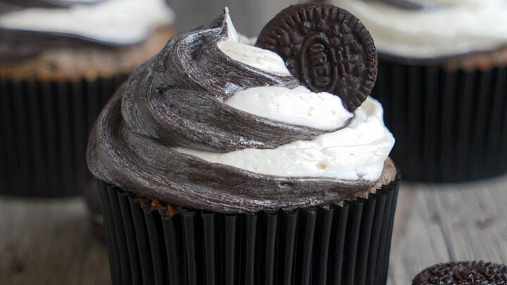 Oreo Cookies & Cream Cupcake · Vanilla cupcake mixed with Oreos, with vanilla cream cheese frosting mixed with crushed Oreos, and topped with whole cookie and Hershey's candy.