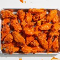Bone-In Chicken Wings (50) · 50 bone-in chicken wings with your choice of sauce. Served with celery or carrots, and blue ...