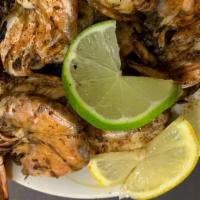 12 Jerk Jumbo Shrimp Dinner · Served with Rice and Peas And Steamed Vegetables
