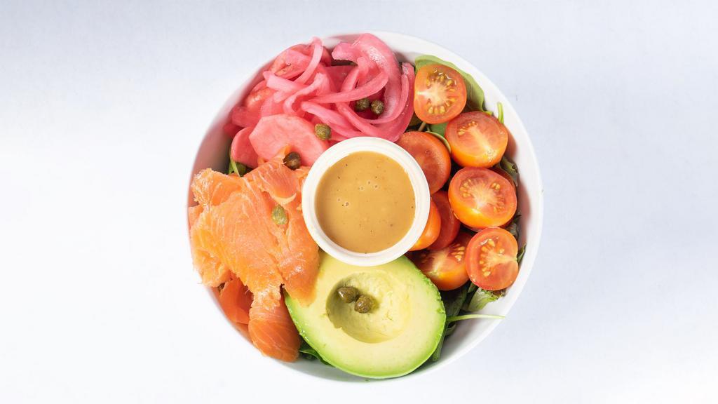 Salmon And Avocado Salad · Arugula, salmon, avocado, tomatoes, capers, pickled radishes and onions, and Sesame ginger dressing.