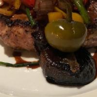 Pork Chop · With cherry peppers, cipolline, and aceto manodori.
