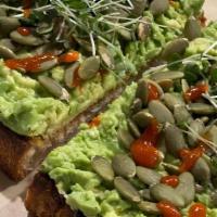 Avocado Toast · Classic, simple avocado toast on organic dark peasant bread. Topped with chile flakes and ma...