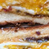 Classic Egg Sandwich - Bacon, Pimento, Cheddar · The classic bec with a mottley twist. Two eggs over medium with hickory smoked bacon and swe...