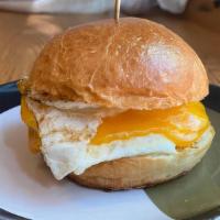 The Simple Egg Sandwich · 2 eggs over easy with cheddar on a brioche bun.