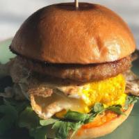 Sausage + Egg Sammie · Pork breakfast sausage, 2 eggs over easy with cheddar cheese, arugula, red pepper sauce, on ...