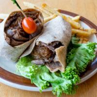 Philly Cheese Steak Wrap · Thinly sliced prime rib of beef and French fries, onion rings rolled in a warm wrap with mel...
