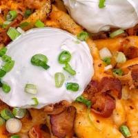 The Big Papas · French Fries with Mexican Cheese, Bacon Bits, Sour Cream and Scallions.