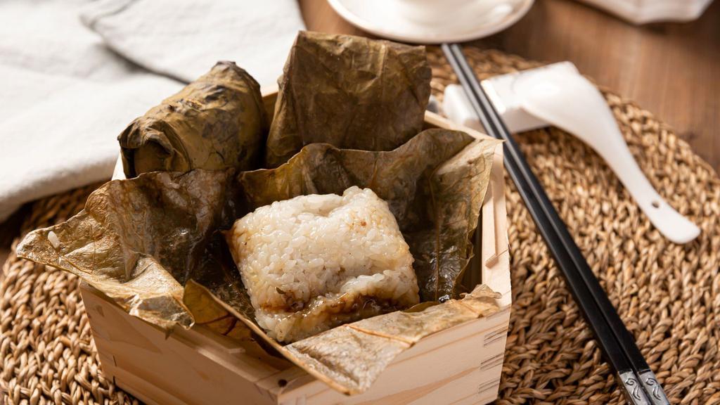 Sticky Rice W. Lotus Leaf  (2) 瑶柱珍珠糯米鸡 · Two pieces of sticky rice with chicken/mushroom/sausage filling.