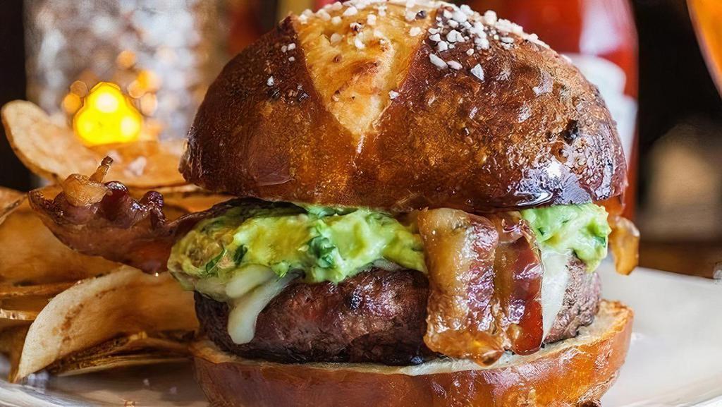 Bacon Fusion Burger · Blend of fresh ground beef and ground bacon.  Topped with Pepper Jack cheese, fresh made guacamole and applewood smoked bacon on a toasted pretzel roll