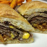 Prime Rib Cheesesteak · Slow roasted, sliced Prim Rib with American cheese, caramelized onions, crispy onions and ro...