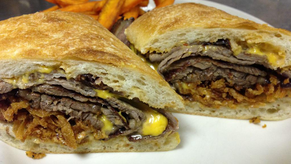 Prime Rib Cheesesteak · Slow roasted, sliced Prim Rib with American cheese, caramelized onions, crispy onions and rosemary mayo, on a toasted club roll