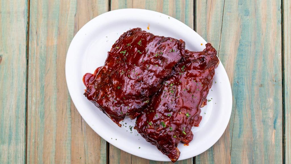 Bbq Ribs Full Rack · Slow cooked, tender baby back ribs, in our southern BBQ sauce. Choice of side.