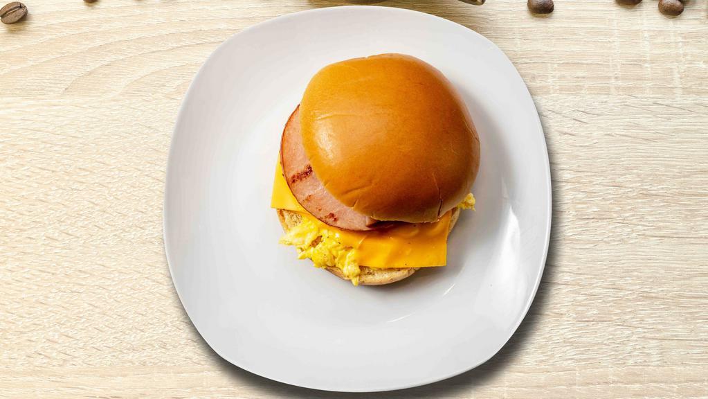 Ham, Egg, And Cheese Sandwich · Ham, scrambled egg, cheddar cheese, sliced tomato and caramelized onions.