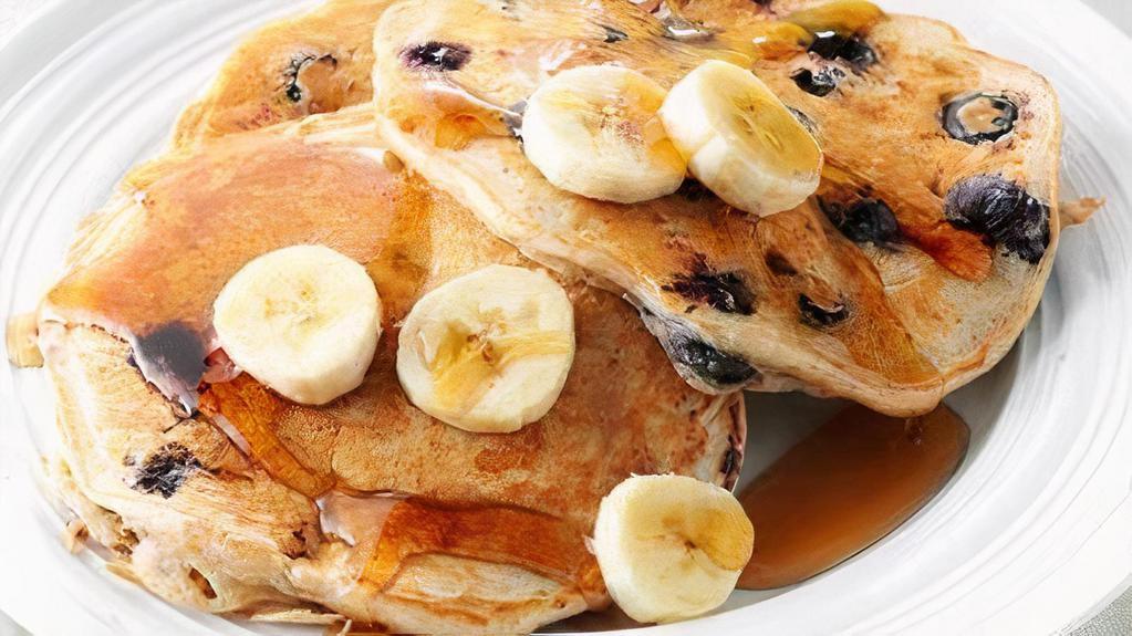 Banana Berry Pancakes · Fluffy banana and berries pancakes cooked with care and love served with butter and maple syrup. Served in pairs.