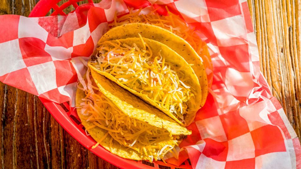 Tacos · Three beef or chicken tacos with tomatoes, lettuce, sour cream, shredded cheese and our famous cheese sauce.
