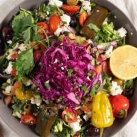 Greek Salad · Tomato, feta cheese, olives, onion, cucumber, red cabbage and stuffed grape leaves. Served o...