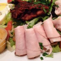 Cobb Salad · Turkey, avocado, tomato, bacon, and hard-boiled egg. Served over romaine with a side of Ital...