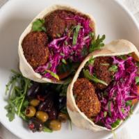 Falafel Pita Pocket Sandwich · Vegetarian meals. Stuffed with lettuce, tomato pickles, cucumbers pickles, and cabbage with ...