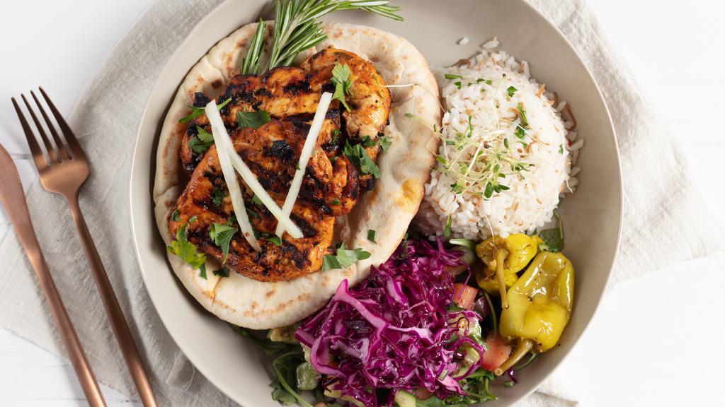 Chicken Kebab · Marinated chicken served with pita, white rice pilaf, shepherd salad & a side of tahini sauce.