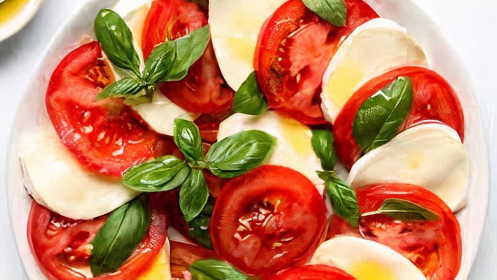 Caprese · Tomato, fresh mozzarella , oregano, basil, extra virgin olive oil.