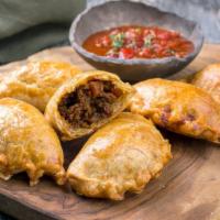 Jamaican Beef Patty · A Jamaican classic of spicy beef prepared in the style of your choice, inside a thick and cr...