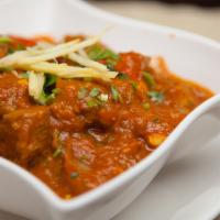 Lamb Bonna · Lamb cooked with onion, tomato and flavored sauce. This is a heavy thick sauce. Served with ...