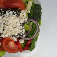 Greek Salad · Feta cheese, black olives, rice stuffed grape leaves over a green salad.