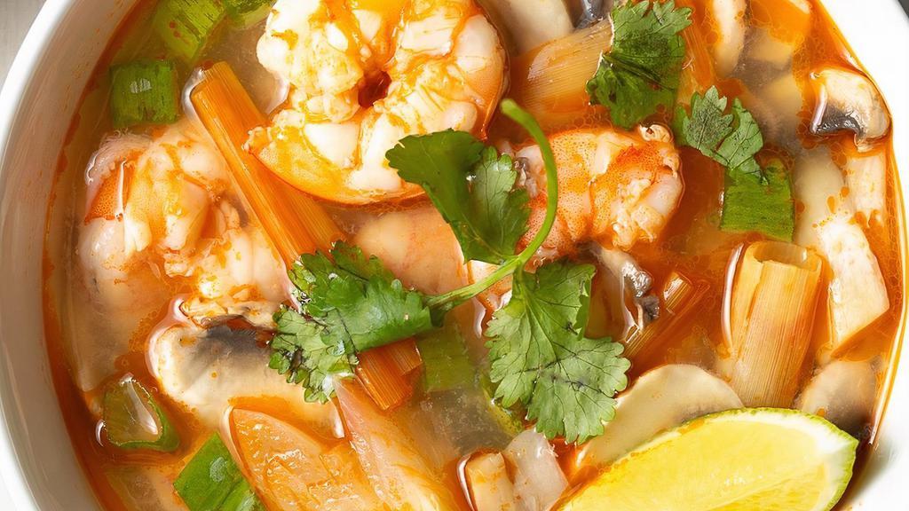 21) Tom Yum Soup (Hot And Sour Soup) · A spicy and sour mixture with Thai herbs, onion, tomato, carrot, mushroom, onion, and cilantro.