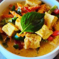 32) Red Curry · Red curry cooked with coconut milk, bamboo shoots, bell pepper, eggplant, carrot, and basil.