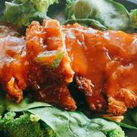 65) Three Flavor Crispy Chicken · Lightly battered chicken deep fried topped with chef's flavor sauce. Served on bed of spinac...