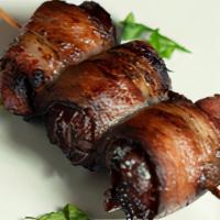 Dátiles Con Beicon (M) · Dates stuffed with almonds and valdeón blue cheese and wrapped in bacon.
