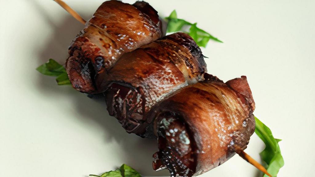 Dátiles Con Beicon (M) · Dates stuffed with almonds and valdeón blue cheese and wrapped in bacon.