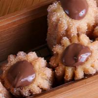 Churros Rellenos De Nutella · Five pieces. Traditional fried dough dusted with cinnamon sugar and filled with Nutella.