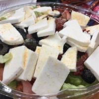 Fresh Mozzarella Salad · Onions, olives, grape tomatoes, sun-dried tomatoes, basil, olive oil, and garlic.