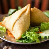 Vegetable Samosa · One piece fried pattie stuffed with mixed veg, beans, and nuts spices.