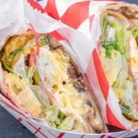 Breakfast Wrap · Scrambled eggs with lettuce, tomato, sauteed onion, garlic mayo and 4 Spice Sauce in a class...