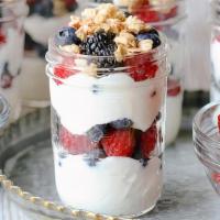 Breakfast Parfait · A delicious glass of rich coconut yogurt, topped with a flavorful almond granola, and a spri...