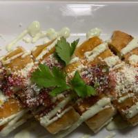 Quesadilla · With mozzarella cheese topped with cilantro sour cream, queso fresco, pico de gallo & guacam...