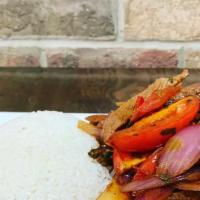 Saltados (Tradicional Peruvian Dish) · Sautéed onions, tomato and soy sauce, served over French fries and white rice
