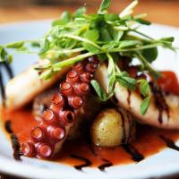 Pieuvre Grillée · Grilled octopus, red pepper coulis, mixed olives, roasted potatoes. Gluten Free.