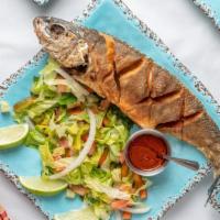 Asa Tibs · Fried fish served with mixed greens salad.