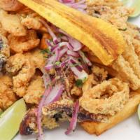 Jalea Mixta · Traditional fried seafood served with yuca, salsa criolla, and tartar sauce.