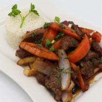 Lomo Saltado · Sautéed filet mignon strips with onions, tomatoes, and soy sauce. Served with French fries a...
