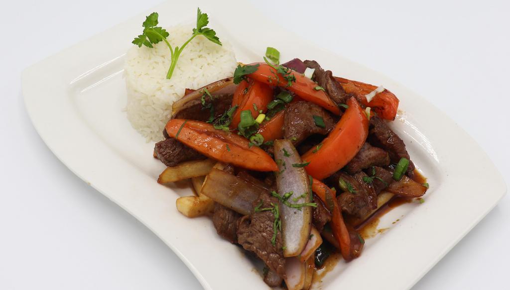 Lomo Saltado · Sautéed filet mignon strips with onions, tomatoes, and soy sauce. Served with French fries and white rice.