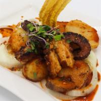 Pulpo A La Parrillada · Grilled octopus strips marinated in chimichurri sauce served with potatoes and grilled veget...