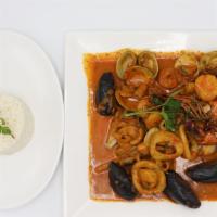 Corvina A Lo Macho · Pan seared corvina, octopus, calamari, shrimp, and clams in Macho sauce. Served with white r...