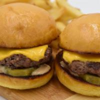 Cheeseburger Sliders · Two grilled slider buns with our Big Island beef mini patties topped with melted Cheddar che...