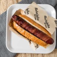 Bacon Wrap Dog · Kosher beef dog wrapped with crispy applewood bacon on our grill pressed bun. topped with di...